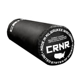 Photo of the bottom of Combat Corner's black with black label 100 lbs. Made in the USA Punching Bag, which shows the under bag specialty Made in Milwaukee CRNR Label.