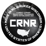 Photo of the bottom of Combat Corner's black with black label 150 lbs. Made in the USA Punching Bag, which shows the under bag specialty Made in Milwaukee CRNR Label.