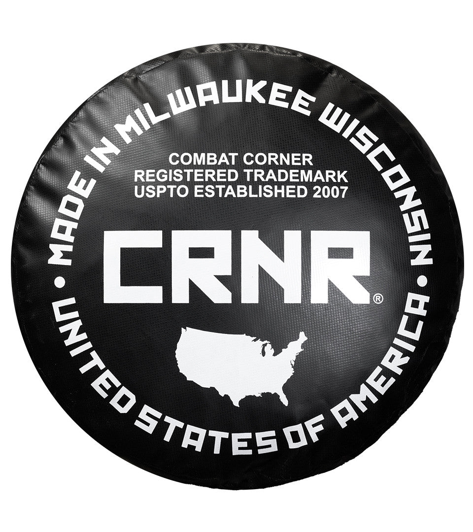 Photo of the bottom of Combat Corner's black with black label 6ft., 150 lbs. Made in the USA Punching Bag, which shows the under bag specialty Made in Milwaukee CRNR Label.