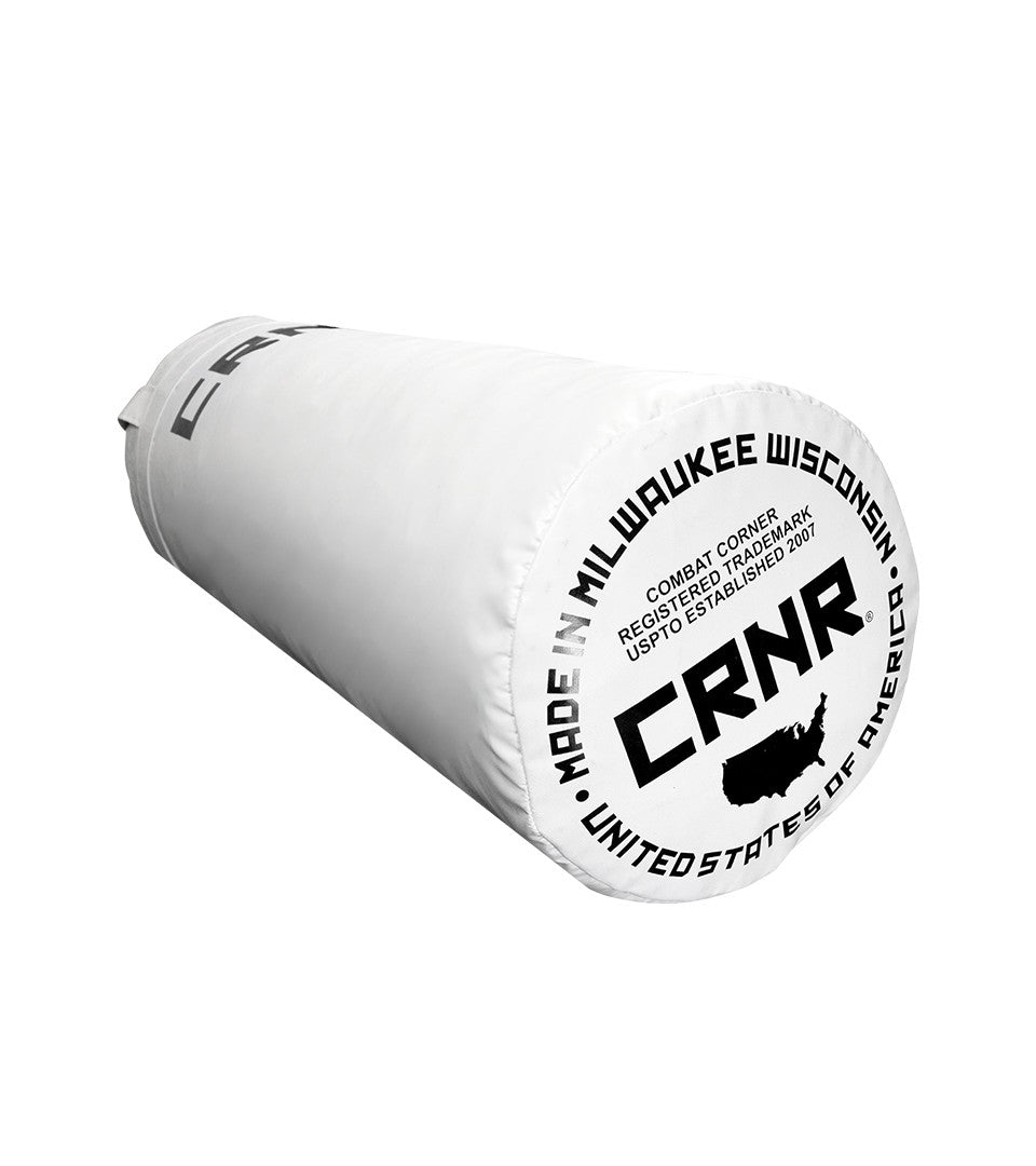 Photo of the bottom of Combat Corner's white with black label 80 lbs. Made in the USA Punching Bag, which shows the under bag specialty Made in Milwaukee CRNR Label.