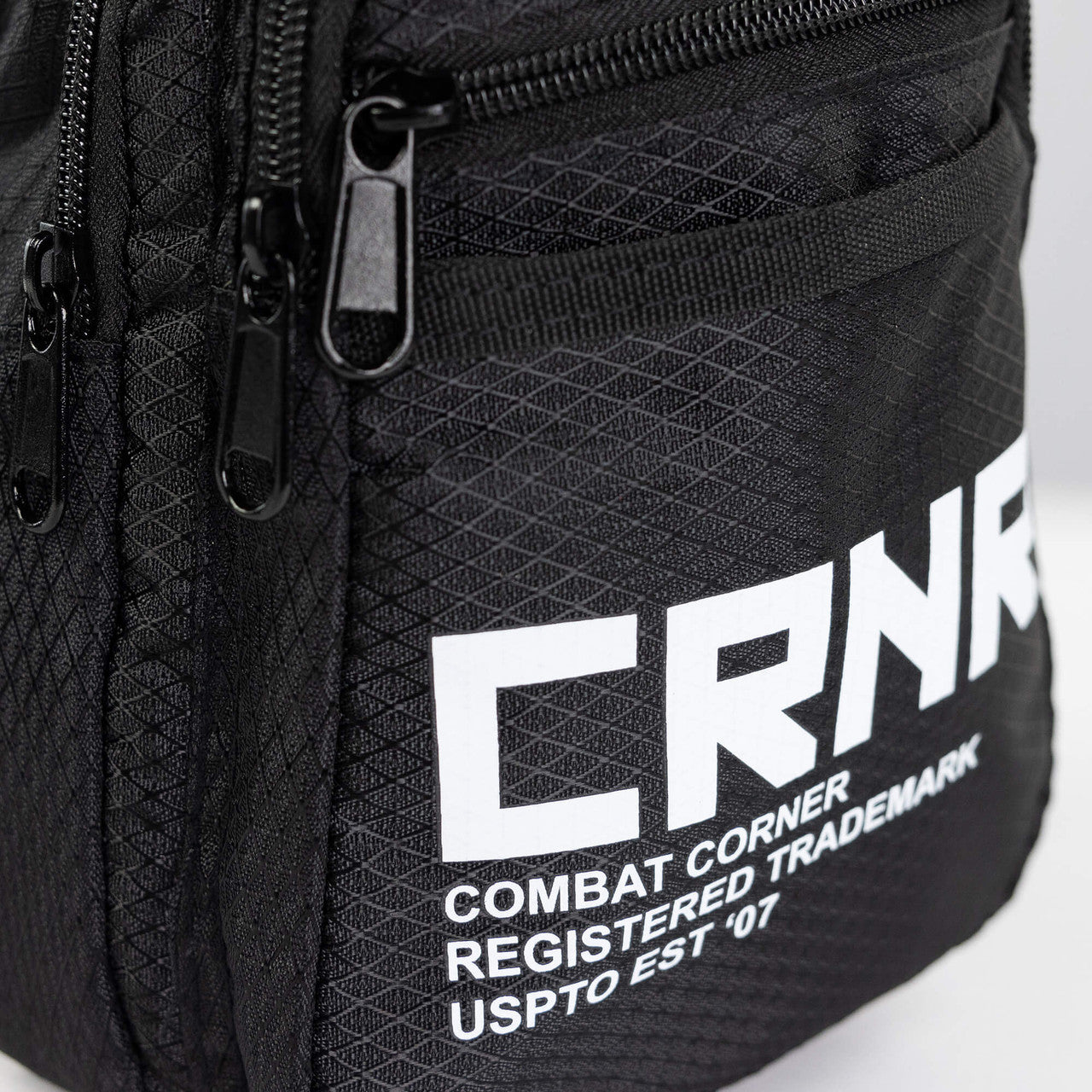 Closeup detail product photo of the deluxe front pocket on the CRNR Sling Bag by Combat Corner