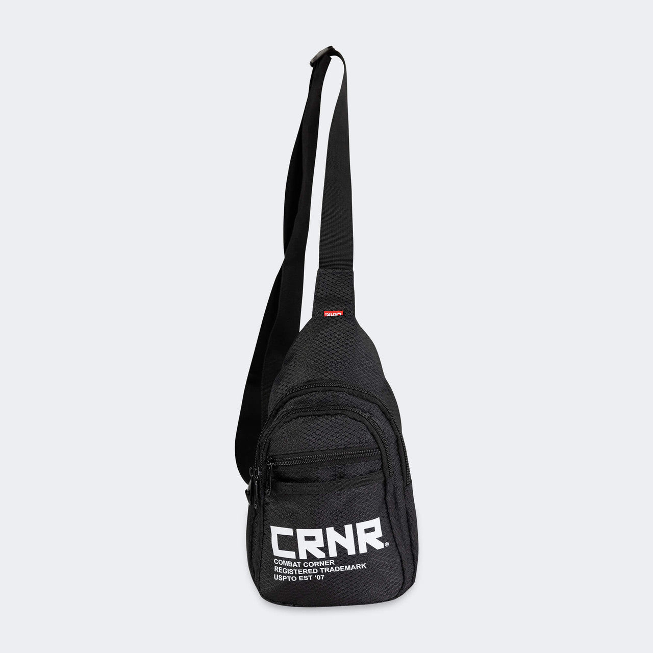 Product photo of the front of the CRNR Sling Bag by Combat Corner showing the bag's extended carrying strap