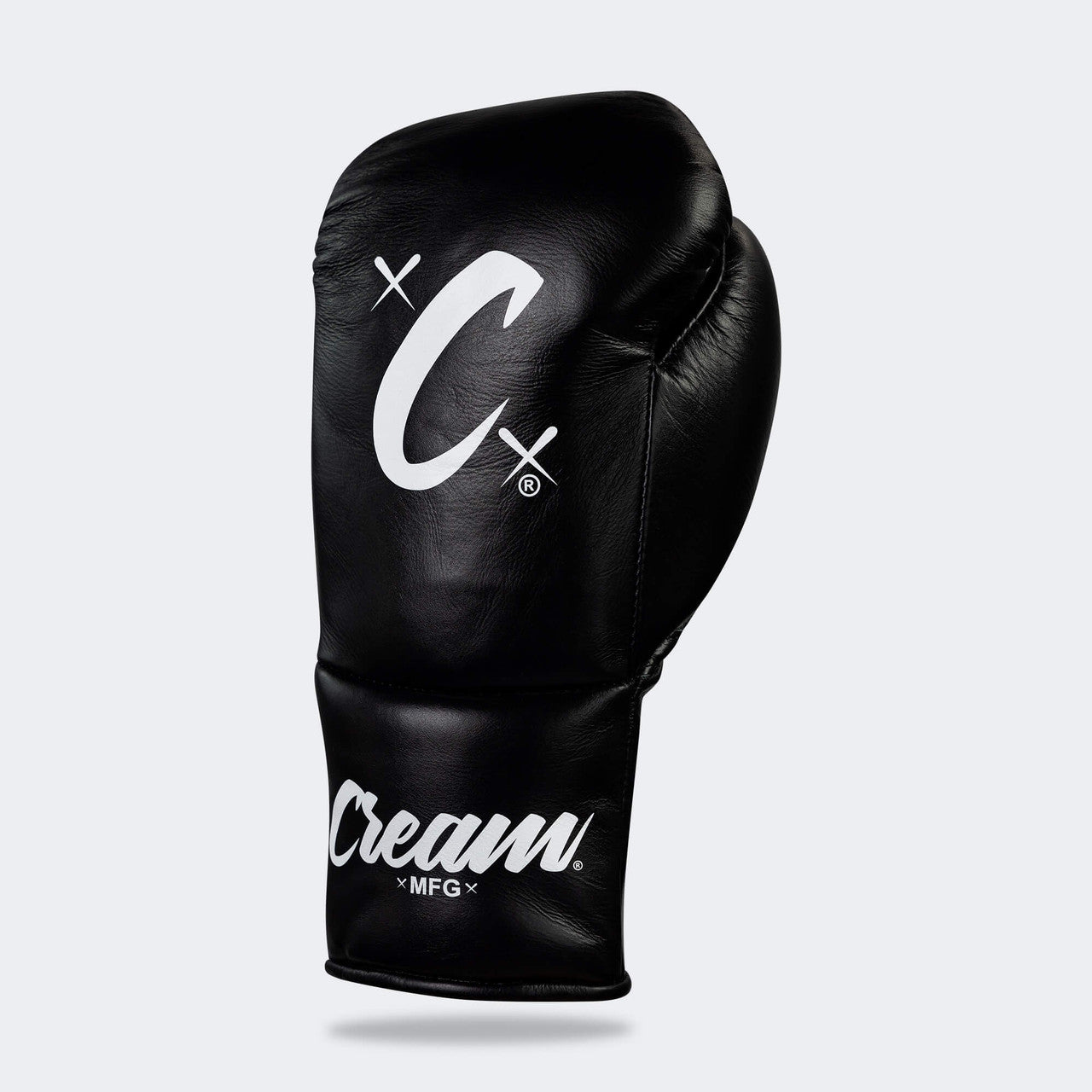 Photo of the front left side of Combat Corner's black Cream TM1 Competition Boxing Gloves, which are Japanese inspired Mexican Boxing Gloves that are hand made in Thailand.
