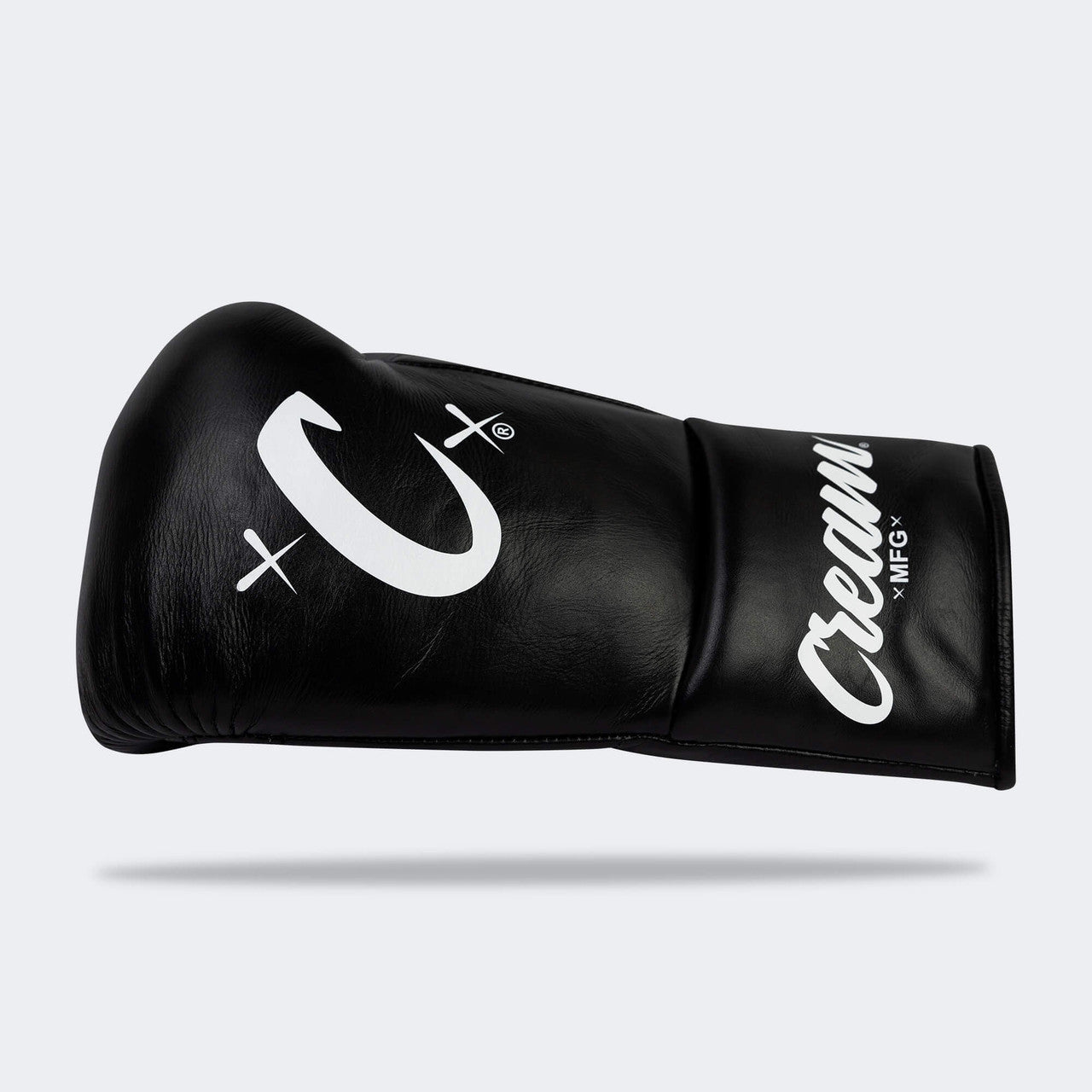 Photo of the horizontal side of Combat Corner's black Cream TM1 Competition Boxing Gloves, which are Japanese inspired Mexican Boxing Gloves that are hand made in Thailand.
