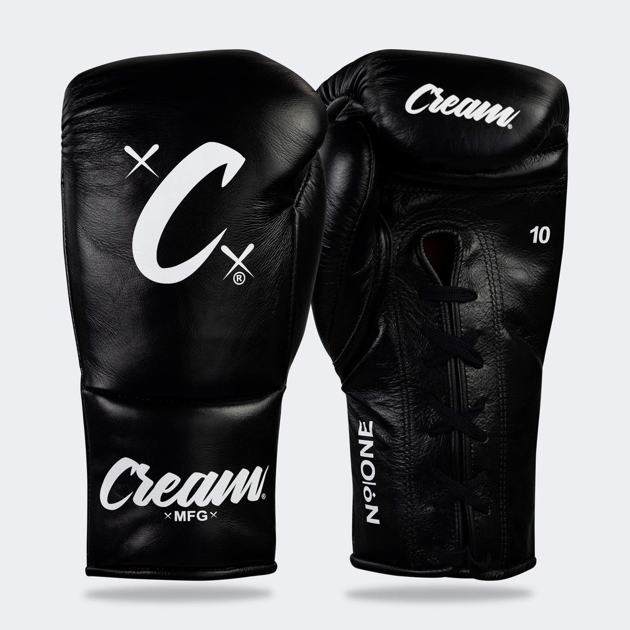 Photo of a pair of Combat Corner's black Cream TM1 Competition Boxing Gloves, which are Japanese inspired Mexican Boxing Gloves that are hand made in Thailand.