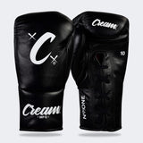 Photo of a pair of Combat Corner's black Cream TM1 Competition Boxing Gloves, which are Japanese inspired Mexican Boxing Gloves that are hand made in Thailand.