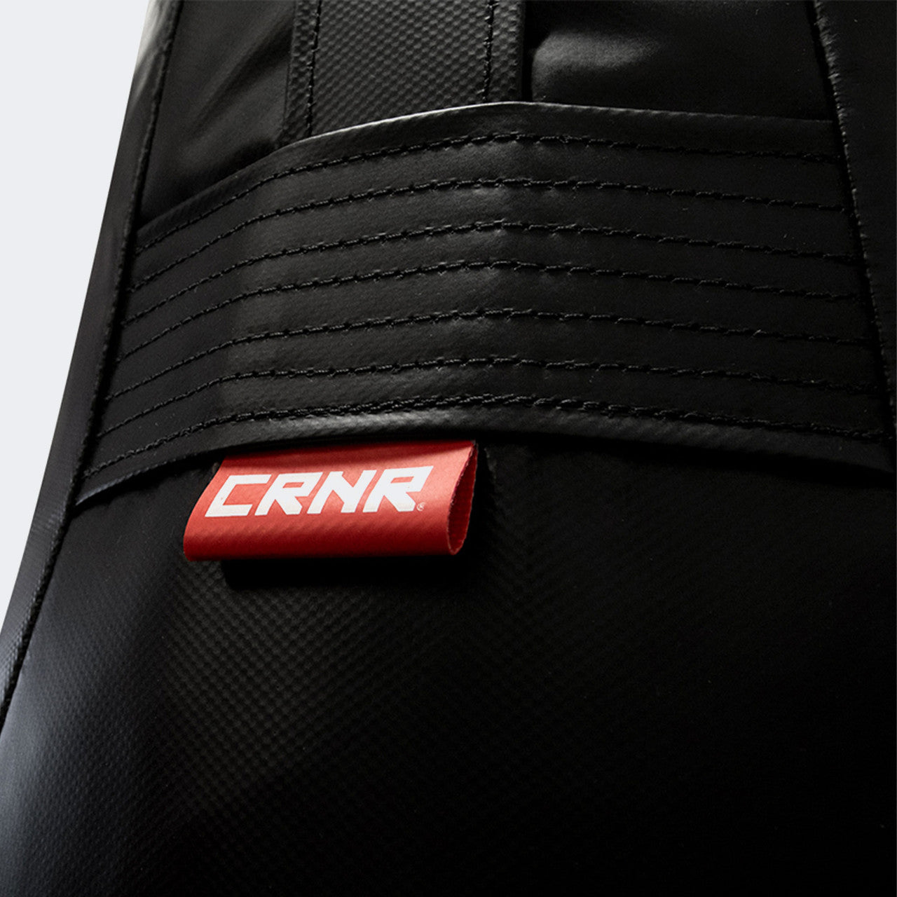 Closeup detail photo of the front of Combat Corner's black Made in the USA Premium Tear Drop Punching Bag.