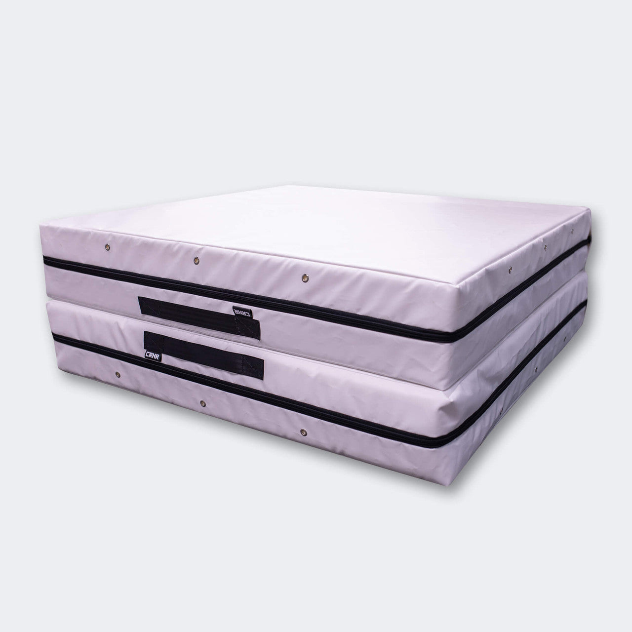 Photo of Combat Corner's white Made in the USA Crash Pad, made for MMA, Wrestling, BJJ, Judo, Martial Arts, and more, fully folded showing how easy it is to stack and store the crash pad.